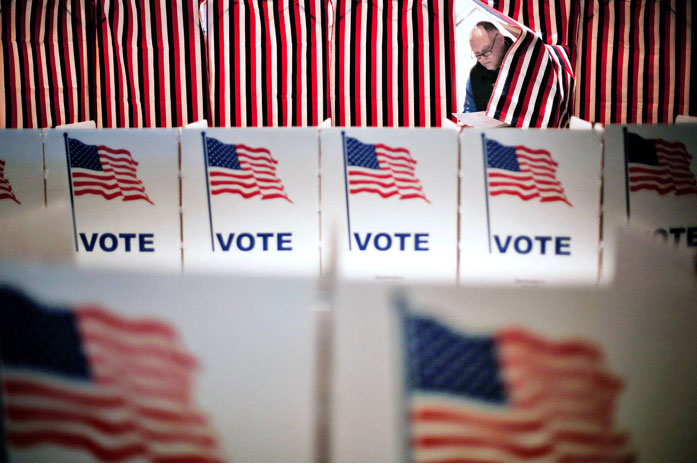 Jim Smith steps out of a voting booth after marking his ballot at a polling... Jim Smith steps out of a voting booth after marking his ballot at a polling site for the New Hampshire primary, Tuesday, Feb. 9, 2016, in Nashua, N.H. (AP Photo/David Goldman) Published Credit: David Goldman/Associated Press