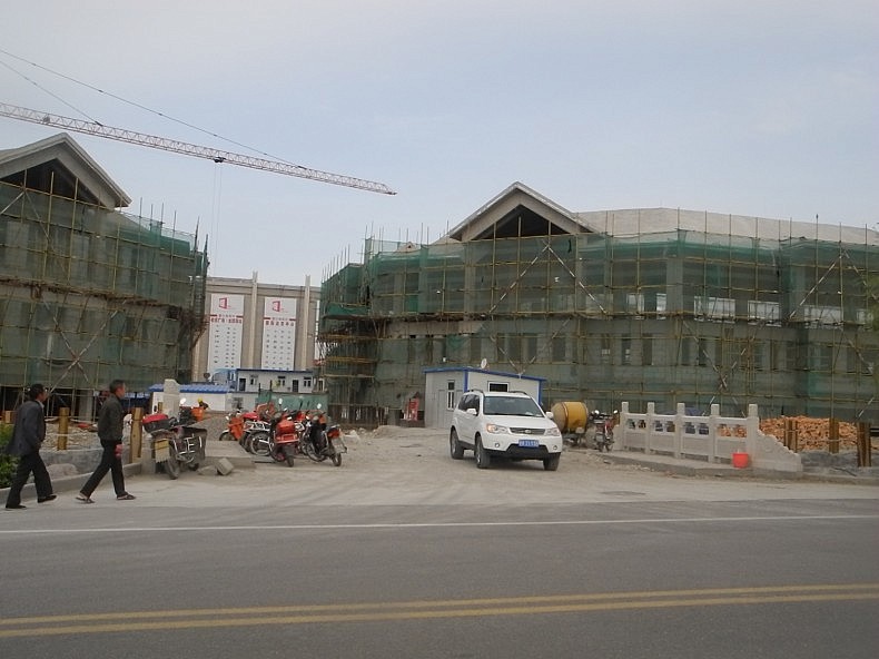 New buildings under construction on the road to the Horgos International Center of Boundary Cooperation, a free trade zone that is shared with Kazakhstan, China\'s only international FTZ. Photo by Wade Shepard.